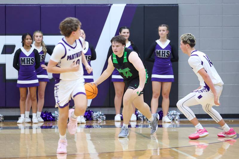 Bishop McNamara's Cale Hamilton brings the ball up during the Fightin' Irish's 61-24 victory over Manteno on Tuesday, Jan. 13, 2026.