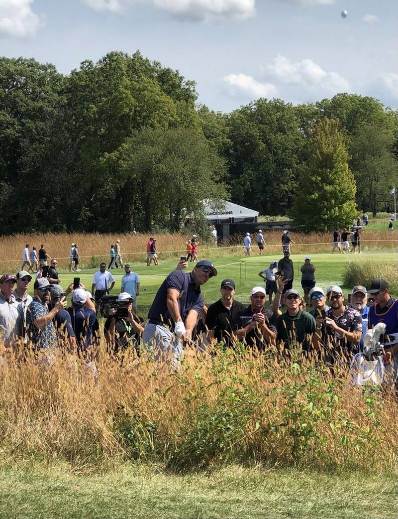 Phil Mickelson chips out of deep rough while the fans watch on hole No. 2 Friday at the LIV Golf tournament at Rich Harvest Farms in Sugar Grove.