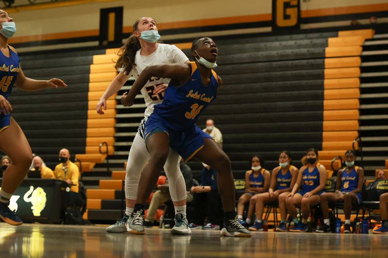 Joliet Central’s Aubrey Weems boxes out Joliet West’s Grace Walsh. Tuesday, Feb. 8, 2022, in Joliet.