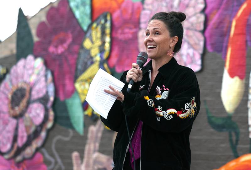 Mural artist Danielle Casali speaks Thursday, Oct. 19, 2023, during the unveiling and ribbon cutting of the new City Hall mural she created. The mural is on the on the south wall of City Hall and was completed with the help of many volunteers who wanted to be a part of the project..
