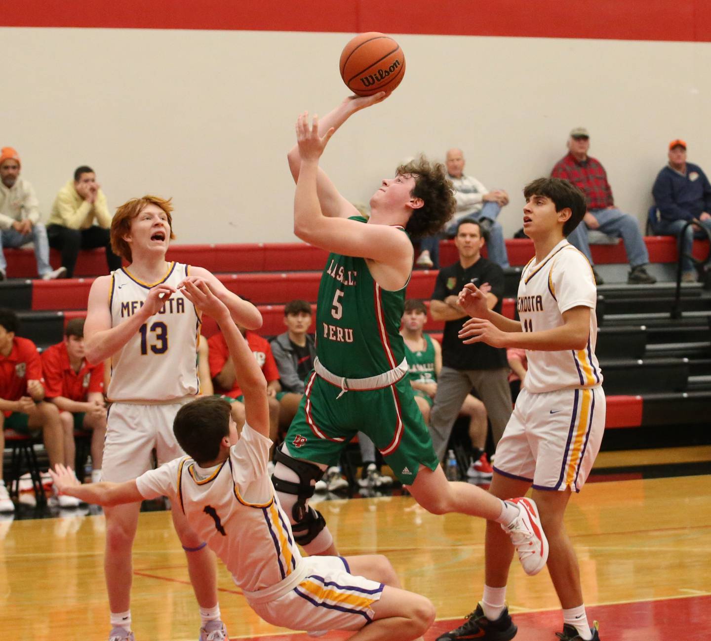 L-P's Tommy Hartman (5) drives in the lane as Mendota's Cale Strouss (1) is called for the block during the Colmone Classic on Tuesday, Dec. 6, 2022 at Hall High School in Spring Valley.