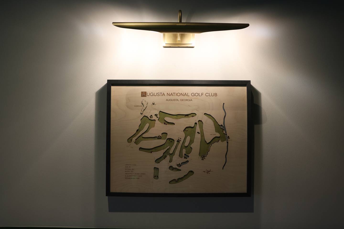Art of famous golf courses, including Augusta National Golf Club, hands on the walls of X-Golf on Tuesday, Oct. 29, 2024 in Shorewood.
