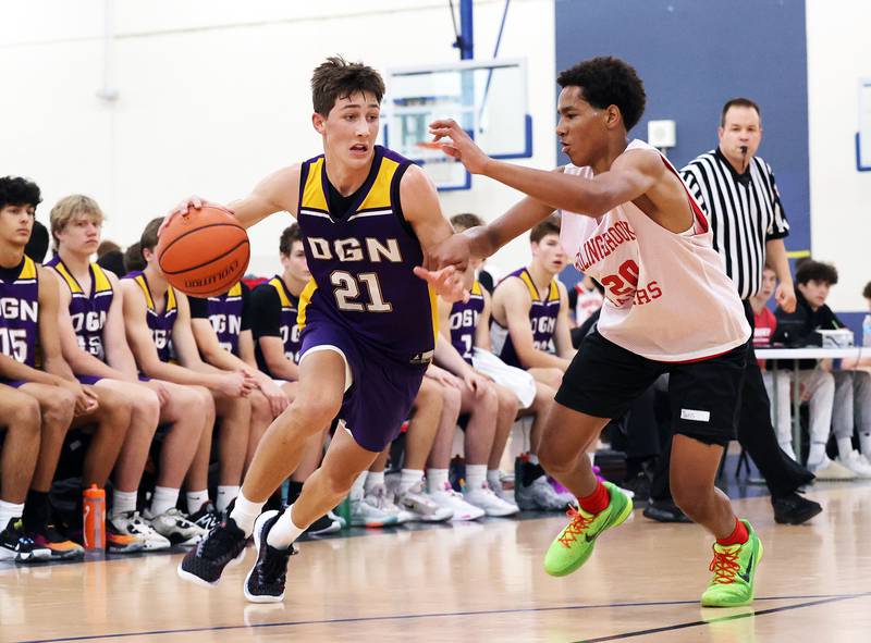 Downers Grove North's Jack Stanton (21) drives to the basket against Bolingbrook during the Riverside Brookfield Shootout for boys varsity basketball in Riverside on Friday, June 16, 2023.
