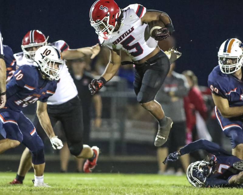 Yorkville's T.J. Harland (5) hurdles over the defense during football game between Yorkville at Oswego Friday, Sept 26, 2025 in Oswego.