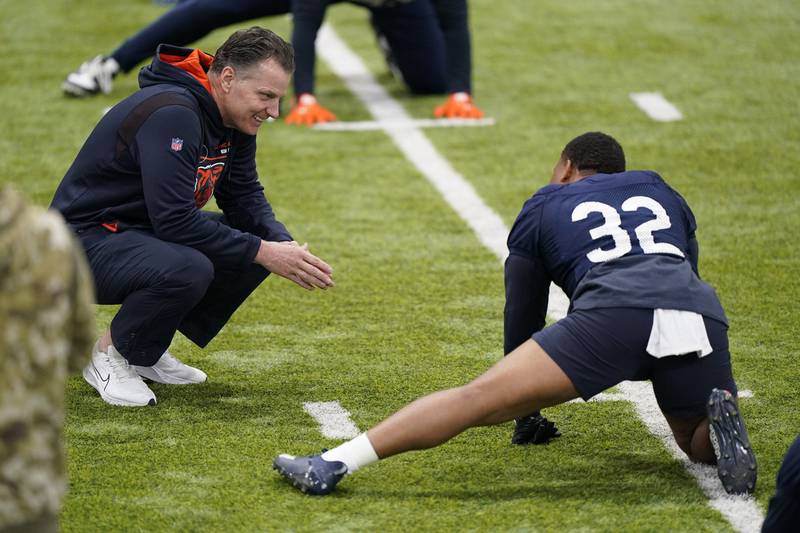 Chicago Bears head coach Matt Eberflus, left, smiles as he talks with running back David Montgomery during the team's voluntary minicamp on Wednesday, April 20, 2022, at Halas Hall in Lake Forest.