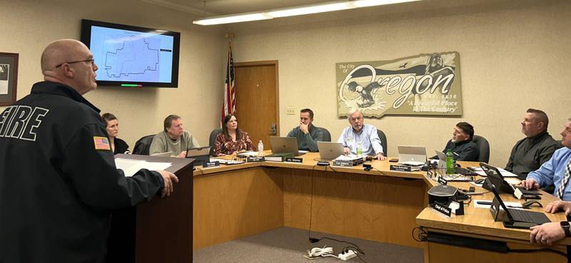 Oregon Fire Chief Michael Knoup (left) addresses city commissioners on Tuesday, Jan. 28, 2025 before a vote was taken on the fire district's zoning variance and special use permit to expand its fire station in the city's river front commercial district.