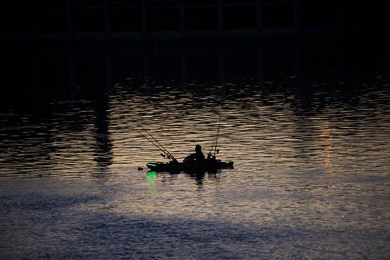 A fisherman tries his luck on the Rock River off of RB&W Park in Rock Falls before the Jaycees fireworks show Friday, July 1, 2022 over Sterling-Rock Falls.