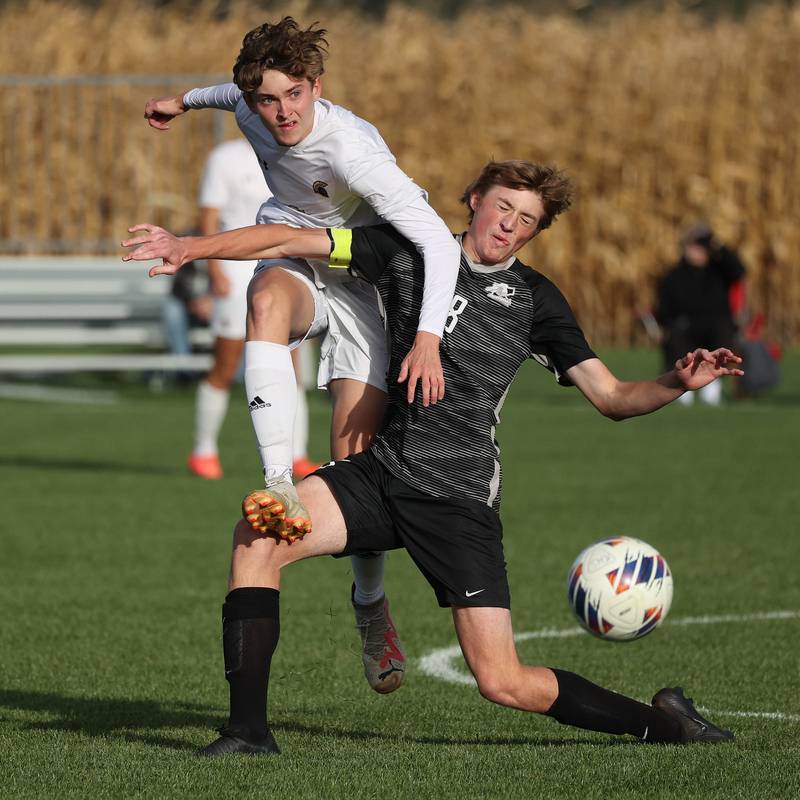 Sycamore's Tyler Hiland (left) kicks the ball away as Kaneland's Matthew Mitchinson tries to block it during their game Monday, Oct. 7, 2024, at Kaneland High School in Maple Park.