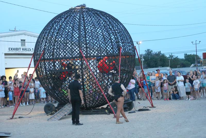 A large crowd watches The Great Pages Circus performers spinning around in a cage on motocross bikes on Monday, June 23, 2025 at the Bureau County Fairgrounds in Princeton. The Great Pages Circus is a family-friendly, traveling circus that blends traditional circus acts with a modern, energetic style.