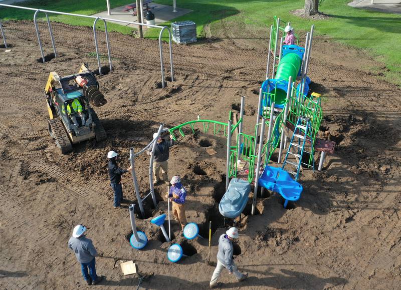 An aerial view of workers installing new playground equipment at Sunset Park on Tuesday, Oct. 17, 2023 in Peru. Installation began this week on about $150,000 of upgraded playground equipment located on the south east part of Sunset Park near the intersection of 2nd and Henry Streets. The city received a grant of $43,000 for the new playground. The work is being constructed by Custom Playgrounds in Rockford. Crews are hoping to have it completed by next week.