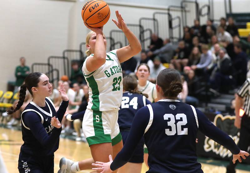 Crystal Lake South's Laken LePage (center) shoots the ball between Cary-Grove's Avery Hoffman (left) and Olivia Leuze (right) during a Fox Valley Conference girls basketball game on Friday, Jan. 23, 2026, at Crystal Lake South High School.