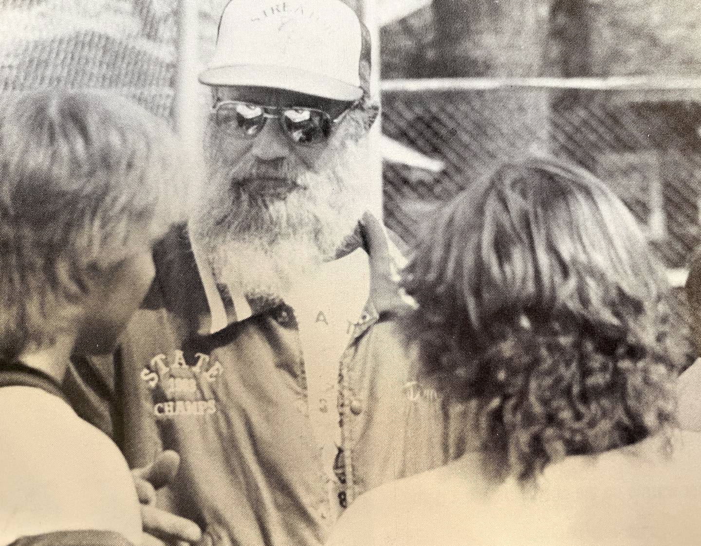 Head coach A.T. Mogill wears his 1983 state champs jacket while talking with players during the 1984 season.