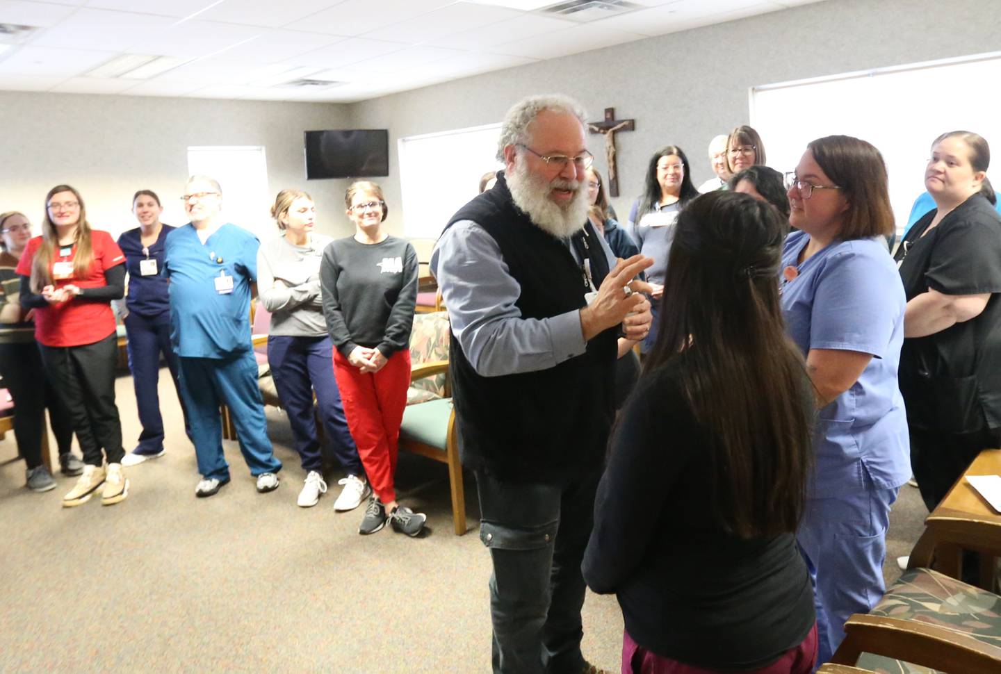 Decan George Schramm blesses the hands of healthcare workers at the new OSF Healthcare clinic on Wednesday, Jan. 10, 2024 in Spring Valley. The clinic is located across from the former St. Margaret's Hospital at the intersection of East First and Mary Streets in Spring Valley.