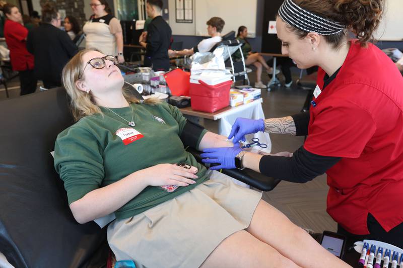 Student Emma Huffaker, gives blood with the help of American Red Cross Haley Buker during the Saint Bede Community Blood Drive on Tuesday, Nov. 4 in the Perino Science Center at St. Bede Academy. The goal was to collect 100 pints this school year. If the school reaches it's goal, the Red Cross will award a $1,000 scholarship to one graduating senior.