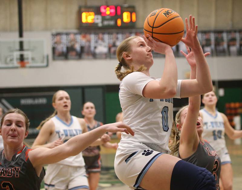 Cissna Park's Addison Lucht drives to the hoop after making her way past Flanagan-Cornell/Woodland's Emma Palaschak during the Class 1A Sectional semifinal game on Tuesday, Feb. 25, 2025 at Midland HIgh School.