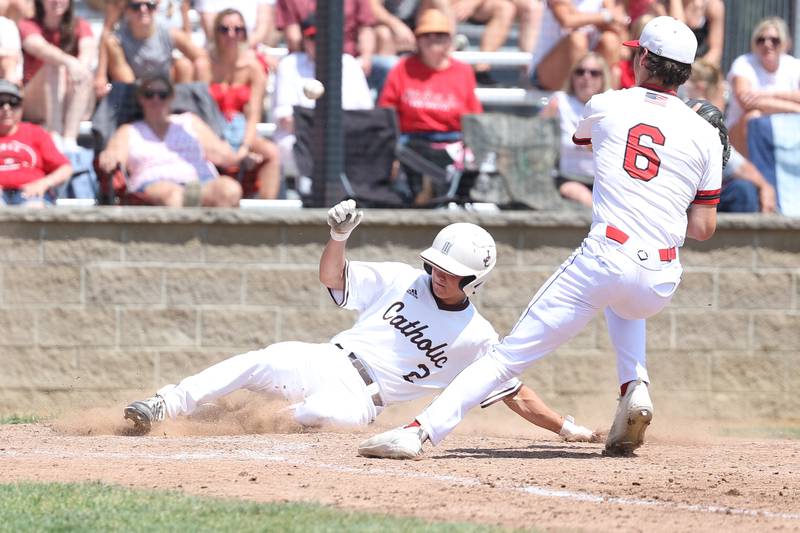 Joliet Catholic’s Tommy Kemp scores on a wild throw against Spring Valley Hall in the Class 2A Geneseo Supersectional on Monday, May 29, 2023 in Geneseo.