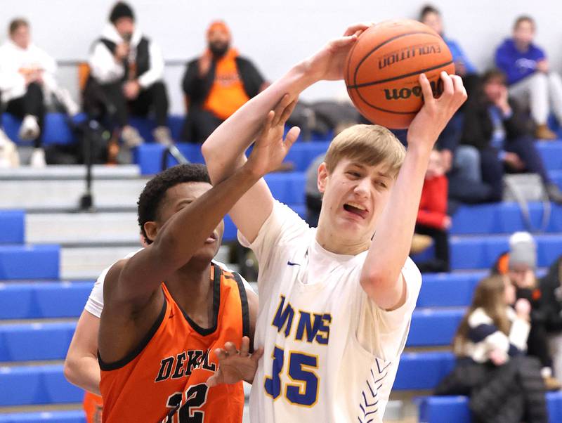 Lyons Township's Ian Polonowski grabs a rebound in front of DeKalb’s Justin O’Neal Monday, Jan. 15, 2023, during their game in the Burlington Central Martin Luther King Jr. boys basketball tournament.