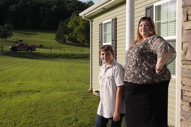 Heather Colley, right, poses with her son, Michah, outside their home Wednesday, Aug. 27, 2025, in Talbott, Tenn. (AP Photo/George Walker IV)