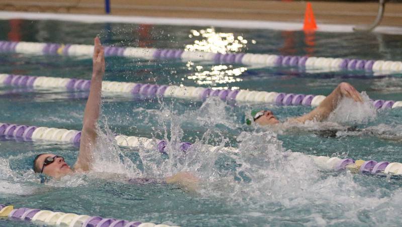 Morrison swimmer Bryar Kuehl and L-P Co-op's Vince Wargo compete in the 100 yard backstroke  event during a triangular meet against Olympia on Wednesday, Jan. 22, 2025 at the Illinois Valley YMCA in Peru.