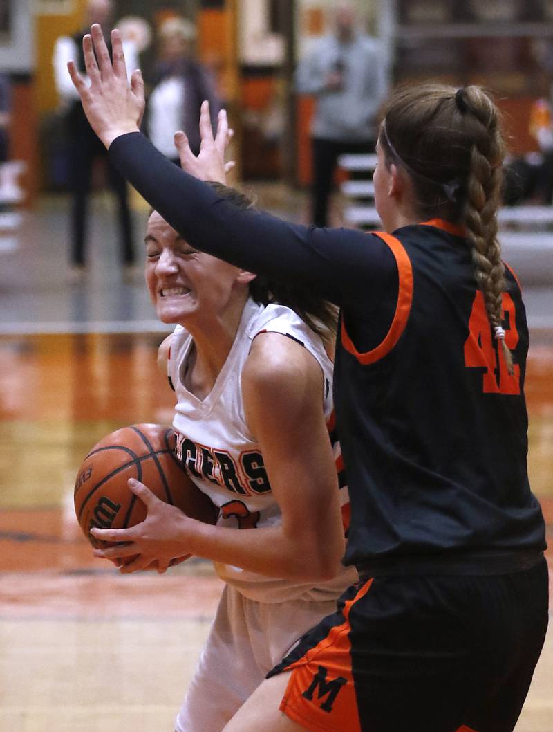 Crystal Lake Central's Kathryn Hamill dives to the basket against McHenry's Madalynn Friedle during a Fox Valley Conference girls basketball game Tuesday, Nov.. 29, 2022, between Crystal Lake Central and McHenry at Crystal Lake Central High School.