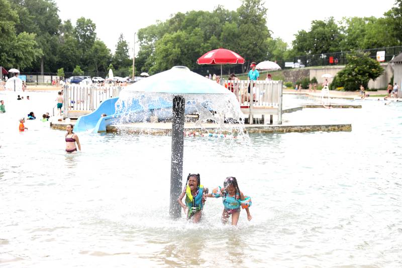 Cherish Daniels, 6, (left) and Madison Daniels, 5, (right) play in the water at the Batavia Park District’s Hall Quarry Beach on Thursday, June 13, 2024.
