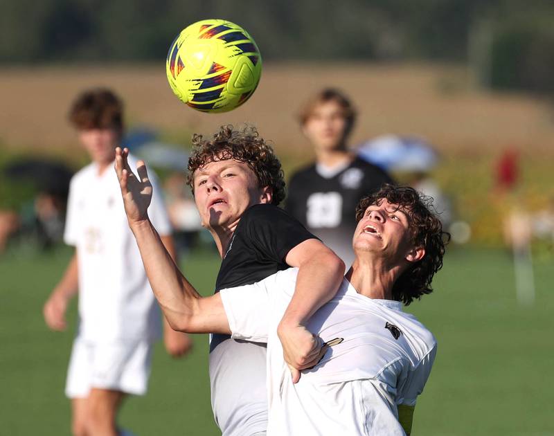Kaneland's Elijah Stoltzner (left) and Sycamore's Noah Daykin fight to get into position to head the ball during their game Wednesday, Sept. 16, 2025, at Kaneland High School in Maple Park.