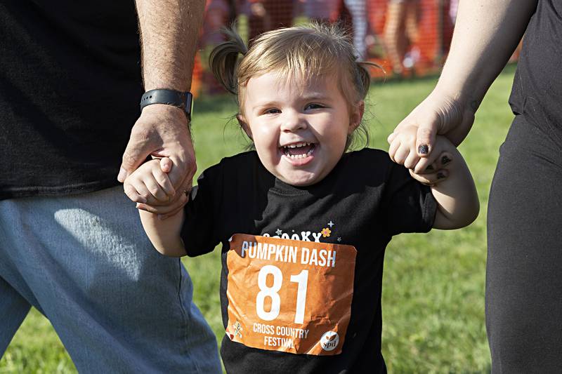Navy Williamsen, 2, of Rock Falls dashes with her parents Saturday, Sept. 30, 2023 during the Sterling Park District Pumpkin Dash. The 31st annual event is held at Hoover Park and brings in thousands of kids and parents for a fun run in the park