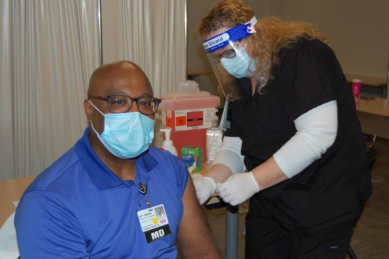 Dr. John Bolden, infectious disease physician at Morris Hospital, receives a COVID-19 vaccination shot.