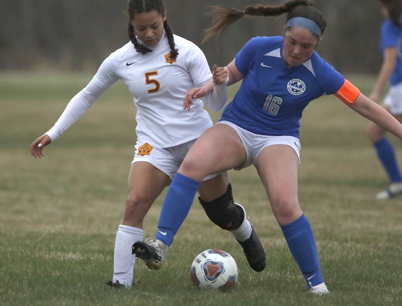 Richmond-Burton's Jasmine McCaskel and Woodstock's Natalie Morrow battle for the ball during a Kishwaukee River Conference soccer match Wednesday, April 30, 2022, between Richmond-Burton and Woodstock at Creekside Middle School.
