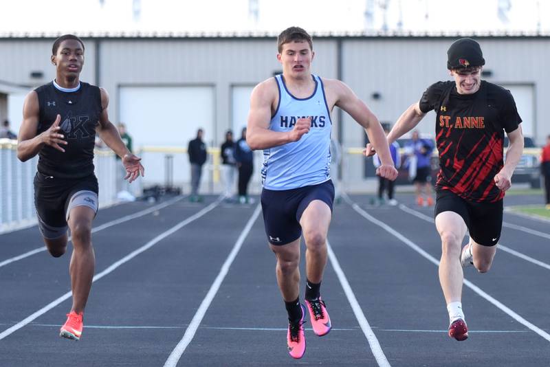 From left, Kankakee's George Noble, Prairie Central's Collin Kilgus and St. Anne's Aden Pinson race to the finish of the 100 meters at the Herscher Invite Friday, May 1, 2026.