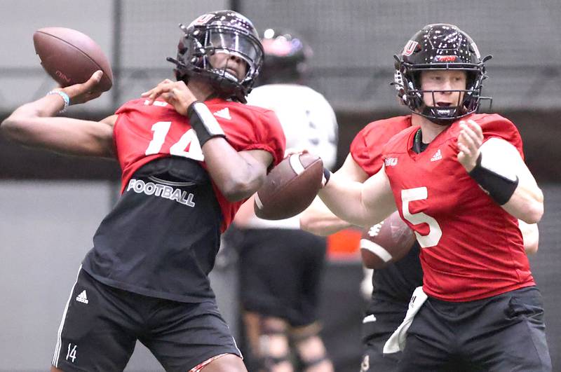 Northern Illinois quarterbacks Mason Kidd (left) and Justin Lynch throw passes during the teams first spring practice Wednesday, March 22, 2023, in the Chessick Practice Center at Northern Illinois University in DeKalb.