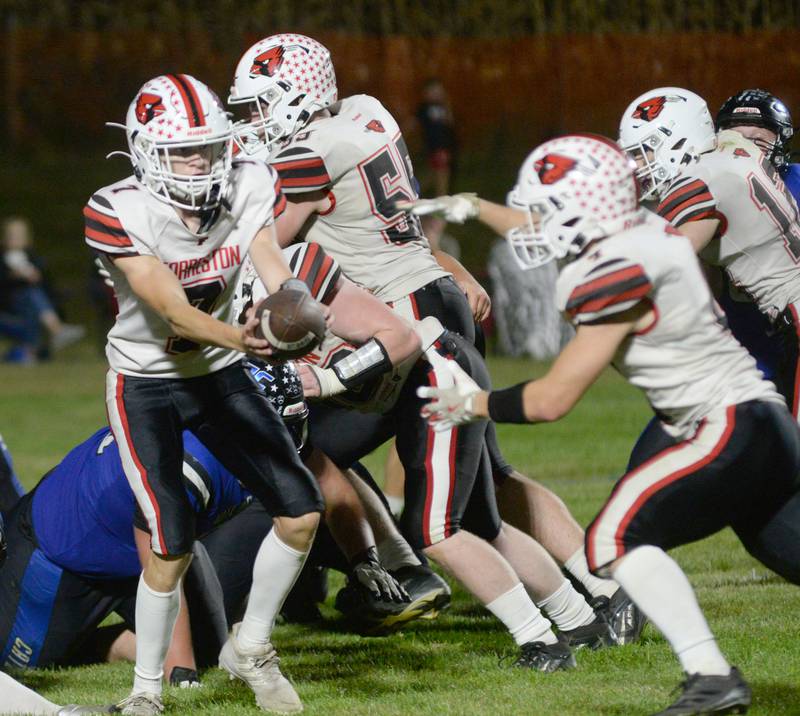 Forreston's Brady Gill (7) prepares to hand the ball off to Christian Riya (4) during action against Eastland-Pearl City at Pearl City High School on Friday, Oct. 3, 2025.