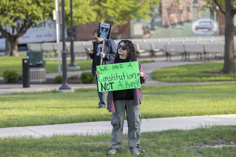 A supporter leans out of a car Friday, May 1, 2026, during a May Day protest at Central Park in Sterling. Indivisible Sauk Valley organized the gathering to continue to voice their displeasure with the Trump Administration.