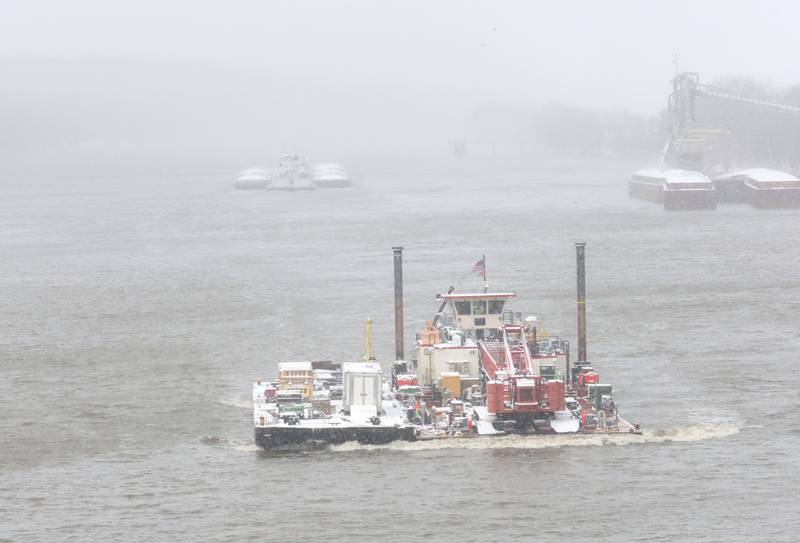 Barges navagate the Illinois River in the snow on Monday, March 16, 2026 near Utica.