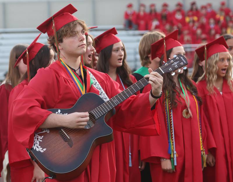 La Salle-Peru Township High School graduate Cam Rankin plays guitar while others sing "Good Riddance" (Time of Your Life) during the L-P Class of 2026 commencement ceremony on Thursday, May 14, 2026 at Howard Fellows Stadium.