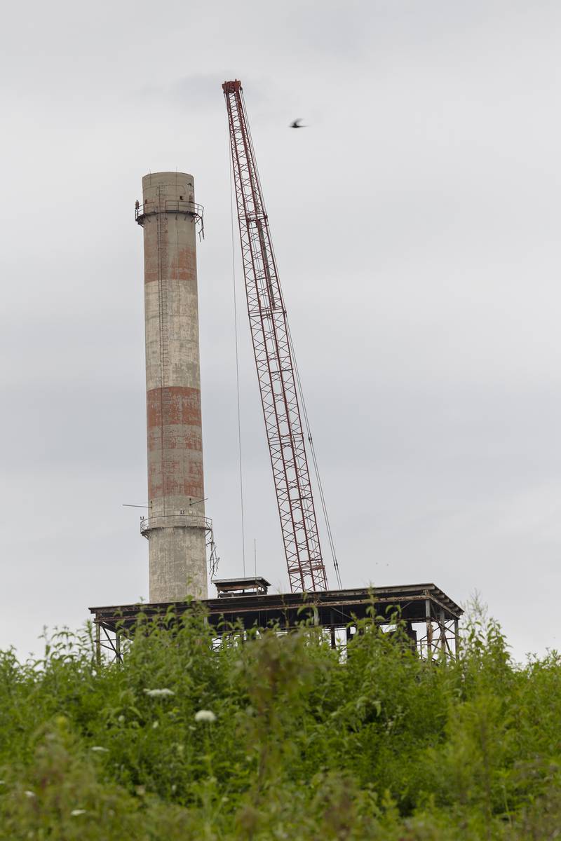 A crane operator works to demolish the 310-foot smokestack at the St. Mary’s Cement plant Monday, July 21, 2025, in Dixon. The plant is located at 1914 White Oaks Lane, Dixon.