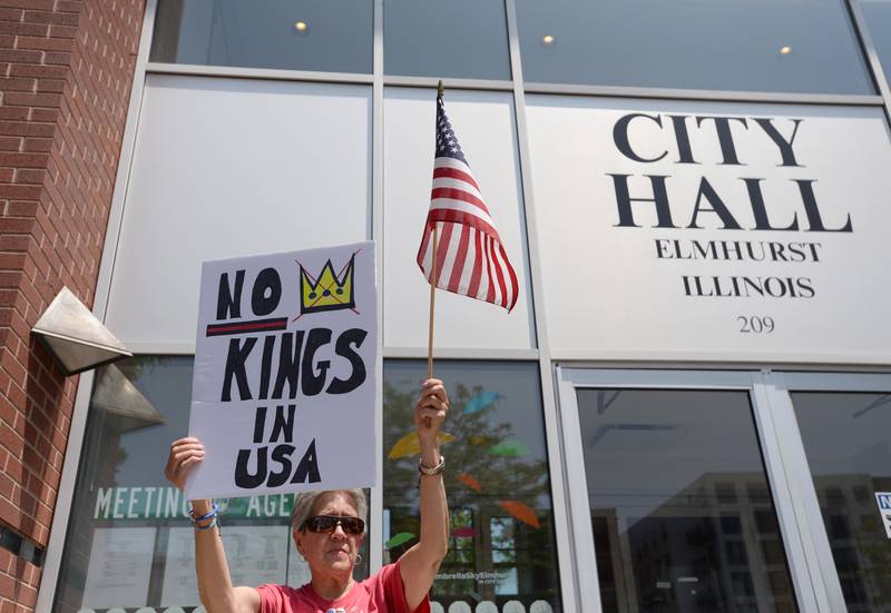 People including Jackie Drake rally outside Elmhurst City Hall while participating in the nationwide No Kings Day Rally Saturday June 14, 2025.
