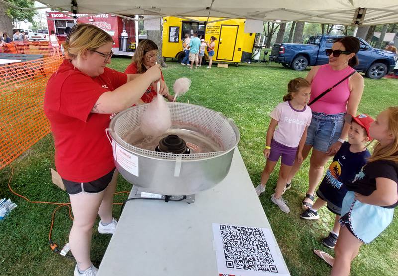 Hall High School cheerleading coach Faith Whightsil prepares cotton candy for a family Saturday, June 10, 2023, during Summerfest at Kirby Park in Spring Valley.
