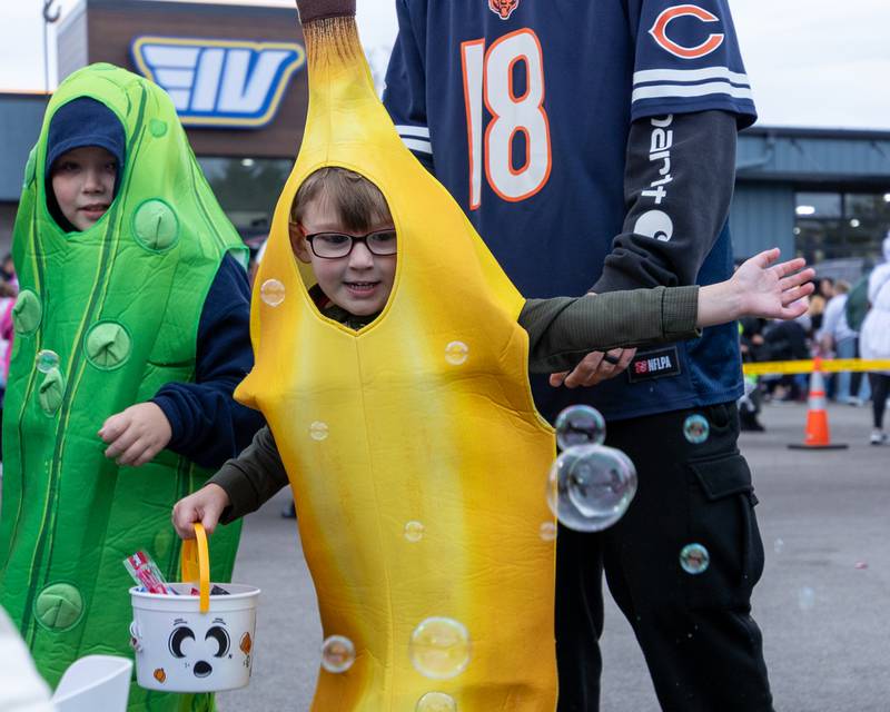 Parker Stachowiak plays with bubbles at the trunk or treat event on Saturday, October 25, 2025 at Illinois Valley Auto Group in Peru.