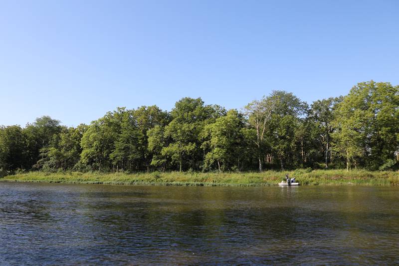 Volunteers arrive to Langham Island by boat across the Kankakee River for a Friends of Langham Island stewardship day on Aug. 9, 2025.