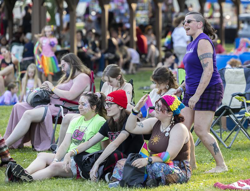 Melissa Pierson dances behind a group of friends  Saturday, June 14, 2025, during Sauk Valley Pride Fest in Dixon.