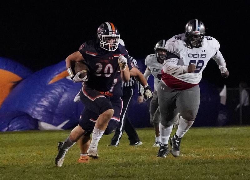 Oswego’s Dylan King (20) carries the ball against Oswego East during a football game at Oswego High School on Friday, Oct. 20, 2023.