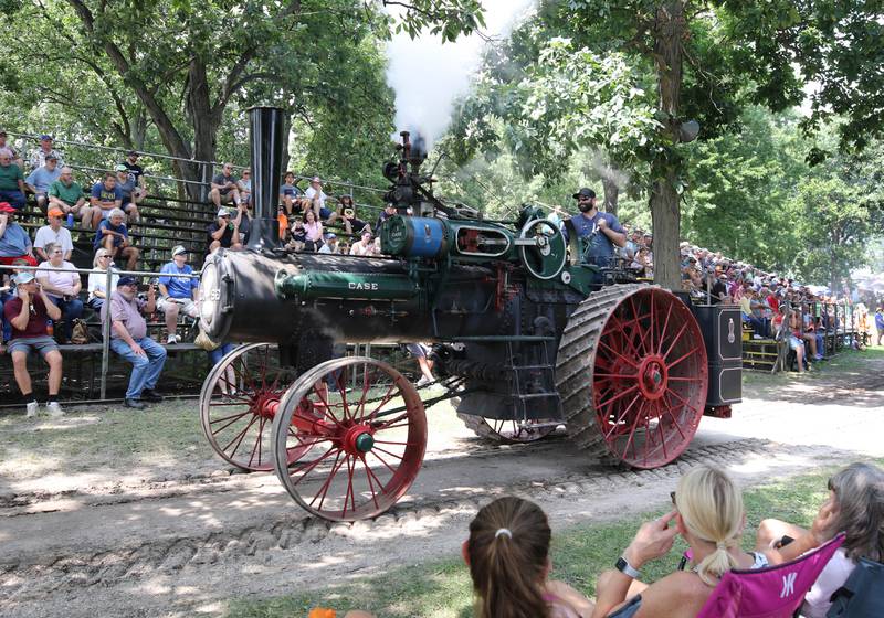 A Case steam powered tractor makes its way by the grand stand during the parade Thursday, Aug. 7, 2025, at the 68th annual Sycamore Steam Show and Threshing Bee at Taylor Marshall Farm on Lukens Road in Sycamore.