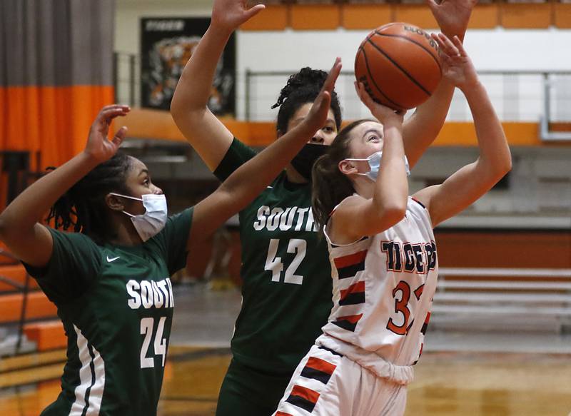 Crystal Lake Central's Kathryn Hamill, right, shoots the ball between Crystal Lake South's Kree Nunnally, left, and Nicole Molgado, center, during a Fox Valley Conference game Wednesday, Jan. 26, 2022, between Crystal Lake South and Crystal Lake Central at Crystal Lake Central High School.