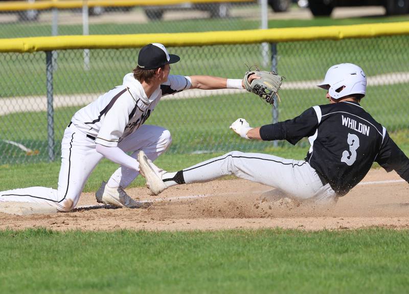 Kaneland's Aidan Whildin slides safely into third as Sycamore's Alex VanMastrigt waits for the throw Tuesday, April 28, 2026, during their game at the Sycamore Community Sports Complex.