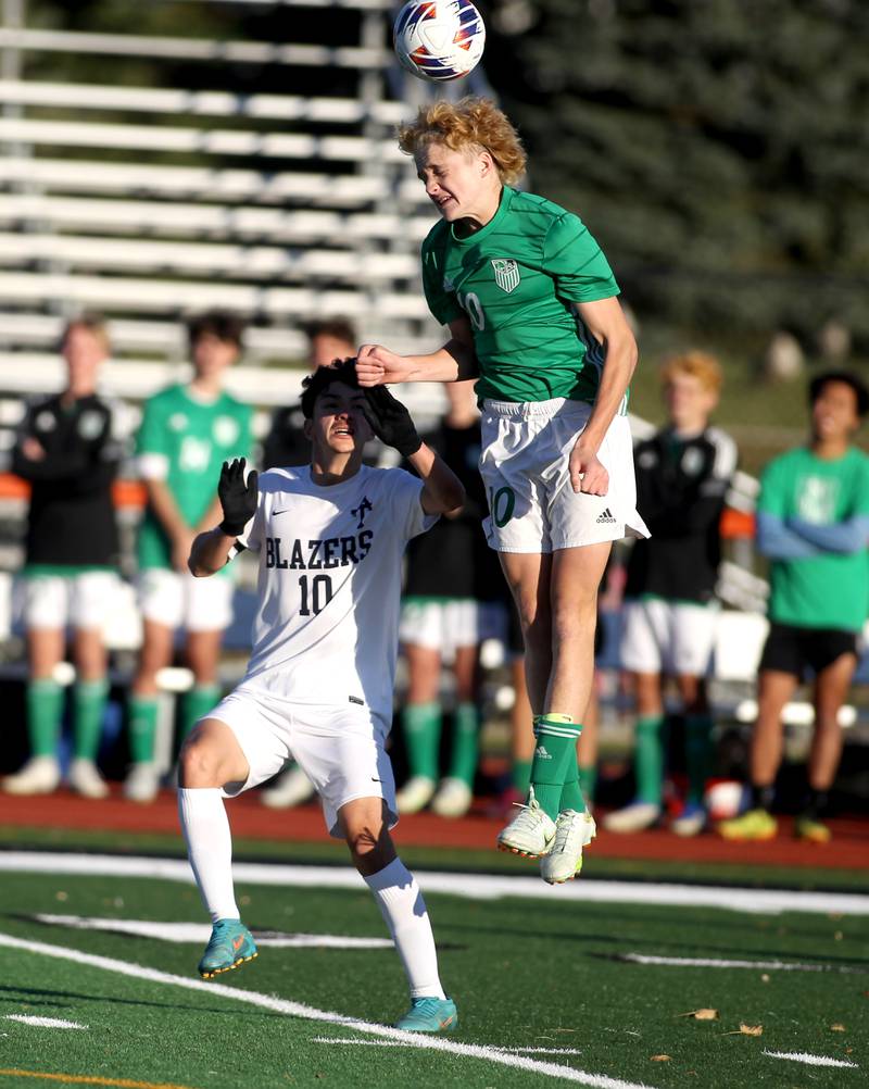 York’s Mateusz Janowski (right) heads the ball over Addison Trail’s Matias Aguilar during a Class 3A St. Charles East Sectional semifinal game on Wednesday, Oct. 26, 2022.
