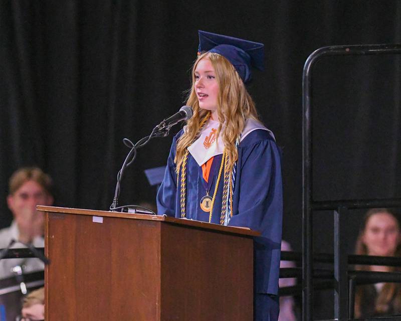 Oswego High School class treasurer Evelyn Snyder presents the class gift to the school during the graduation ceremony on Saturday May 17, 2025, held at the Convocation Center in DeKalb.