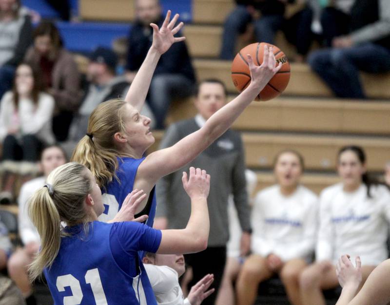 Wheaton North’s Mira Spillane (center) reaches for a rebound during the Class 4A St. Charles North Regional final against St. Charles North on Thursday, Feb. 16, 2023.