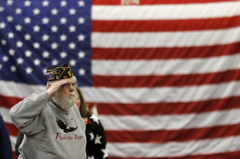 U.S. Navy veteran Art Erickson salutes the American Flag during the Veterans Day ceremony Wednesday, Nov.8, 2023, at Alden-Hebron High School in Hebron.