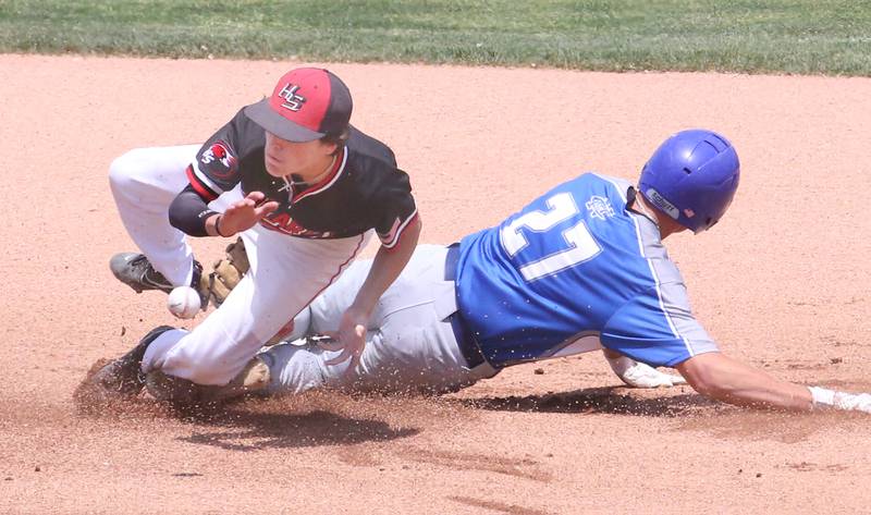 Newman's Brendan Tunink slides in safe to second base as Henry-Senachwine's Teagan Williams misses the throw during the Class 1A State semifinal game on Friday, June 2, 2023 at Dozer Park in Peoria.